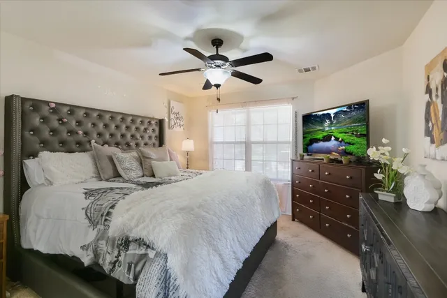 a bedroom with a bed and a flat screen tv