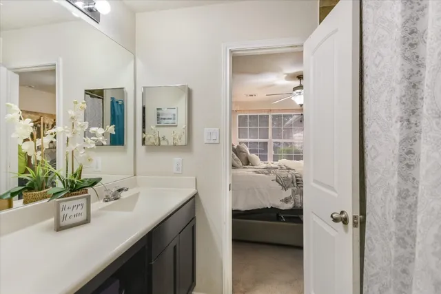 a en suite bathroom with a granite countertop sink a toilet and shower