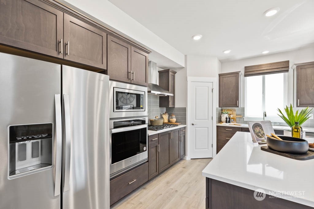 4414 228th Place South East, Unit MC5 Bothell, WA 98021 - Photo 16 of 33 a kitchen with stainless steel appliances a refrigerator sink and stove