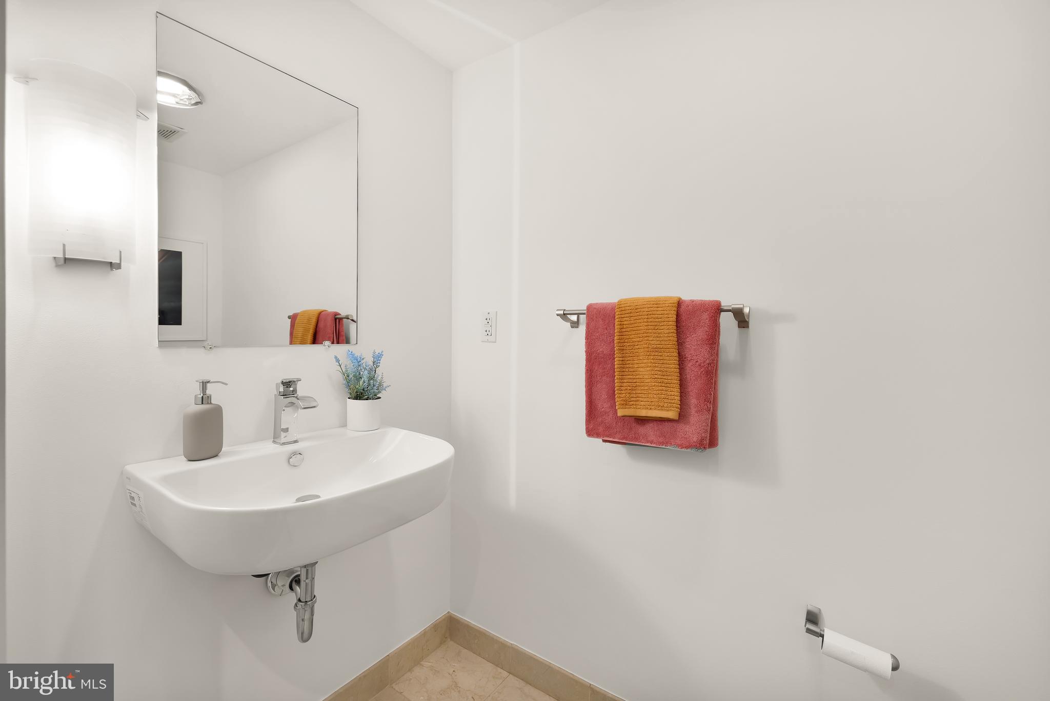 1390 V Street Northwest, Unit 413 Washington, DC 20009 - Photo 12 of 22 a bathroom with a sink and a mirror
