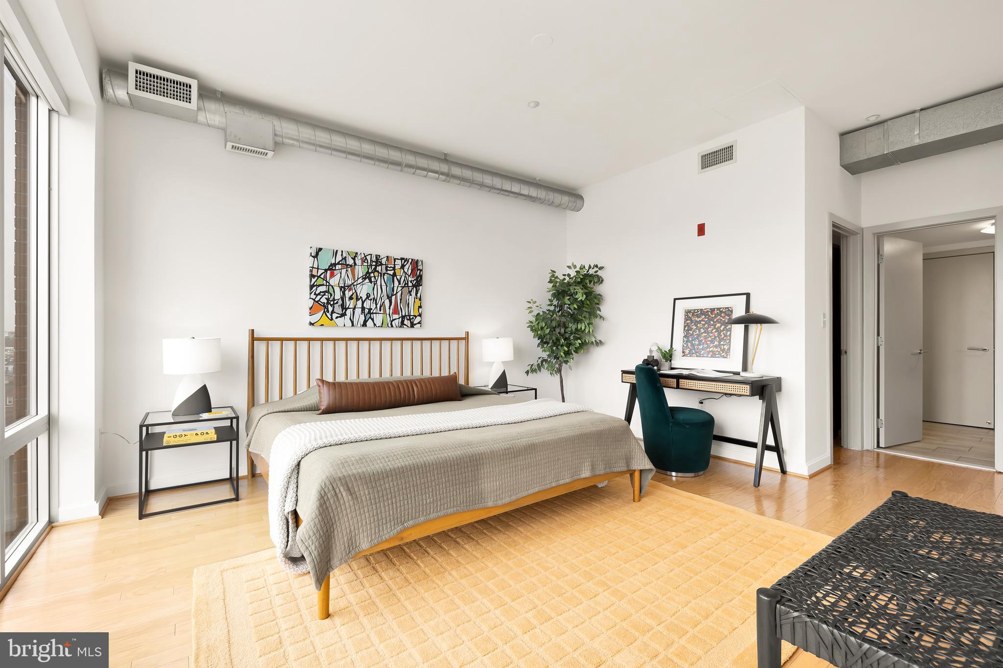 1390 V Street Northwest, Unit 413 Washington, DC 20009 - Photo 17 of 22 a bedroom with a bed and a table in it