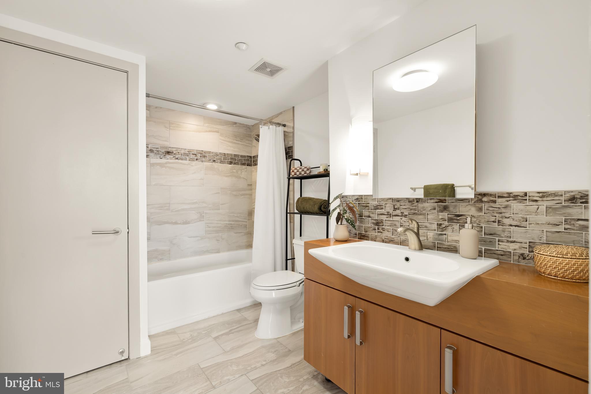 1390 V Street Northwest, Unit 413 Washington, DC 20009 - Photo 20 of 22 a bathroom with a sink and a mirror