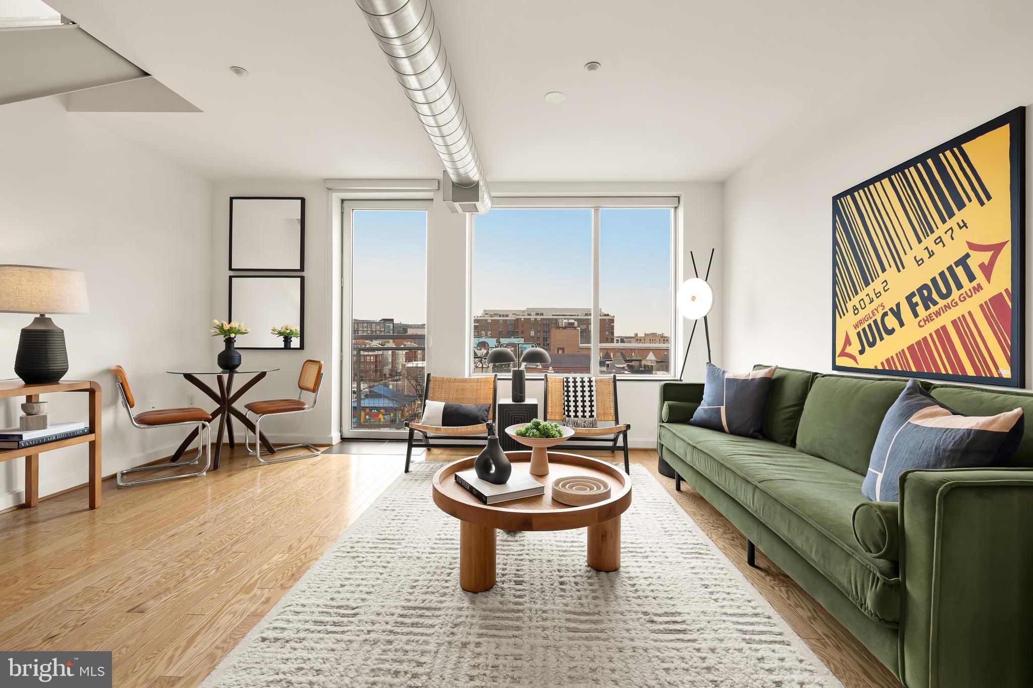 1390 V Street Northwest, Unit 413 Washington, DC 20009 - Photo 2 of 22 a living room with furniture a rug and a floor to ceiling window