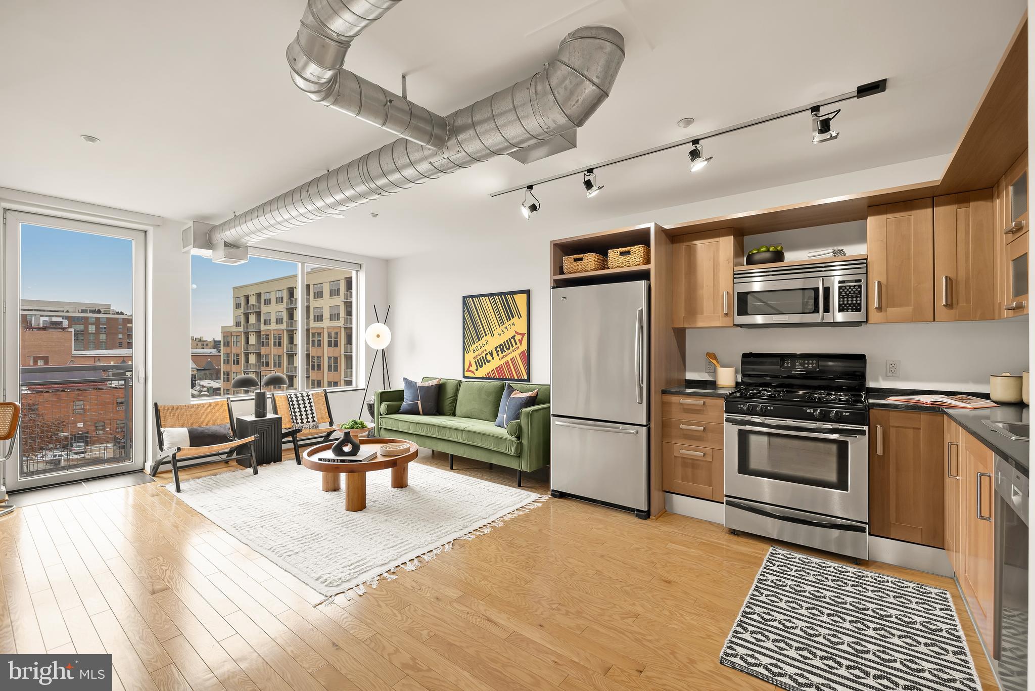 1390 V Street Northwest, Unit 413 Washington, DC 20009 - Photo 5 of 22 a living room with stainless steel appliances kitchen island granite countertop a stove and a refrigerator