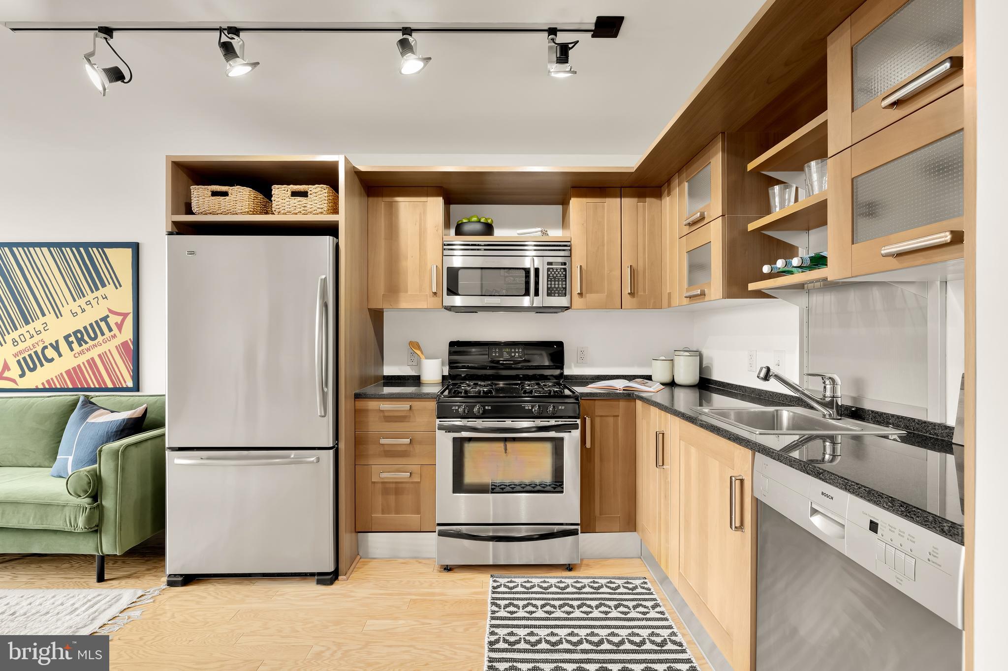 1390 V Street Northwest, Unit 413 Washington, DC 20009 - Photo 6 of 22 a kitchen with stainless steel appliances granite countertop a refrigerator and a stove