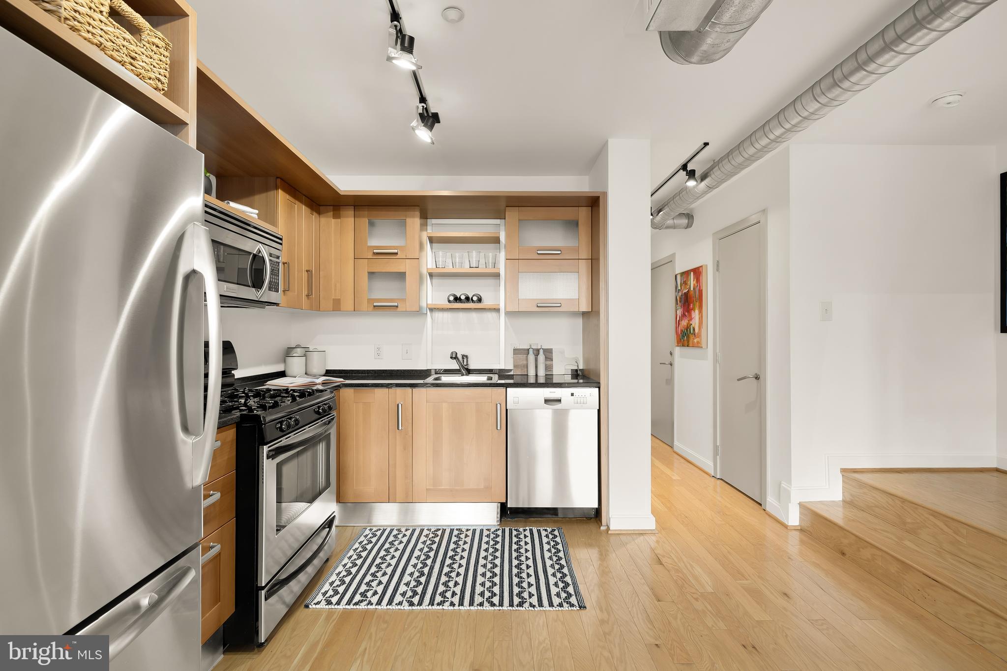 1390 V Street Northwest, Unit 413 Washington, DC 20009 - Photo 7 of 22 a kitchen with stainless steel appliances granite countertop a refrigerator and a sink