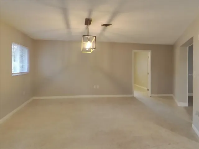 an empty room with a empty space and a window