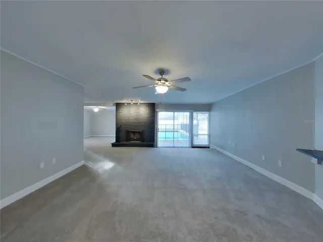 a view of a livingroom with a ceiling fan and window