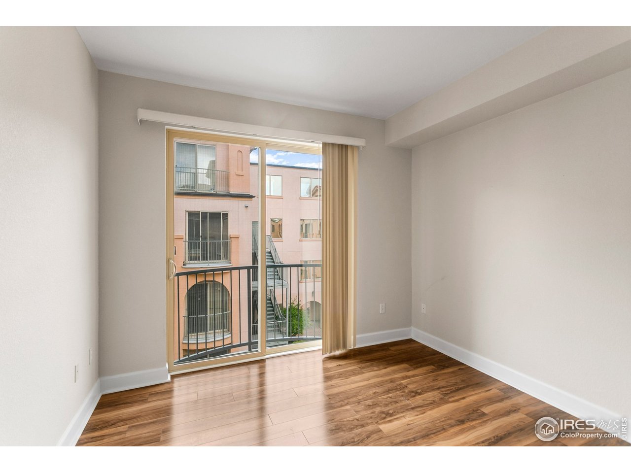 4500 Baseline Road, Unit 3302 Boulder, CO 80303 - Photo 22 of 22 an empty room with wooden floor and windows
