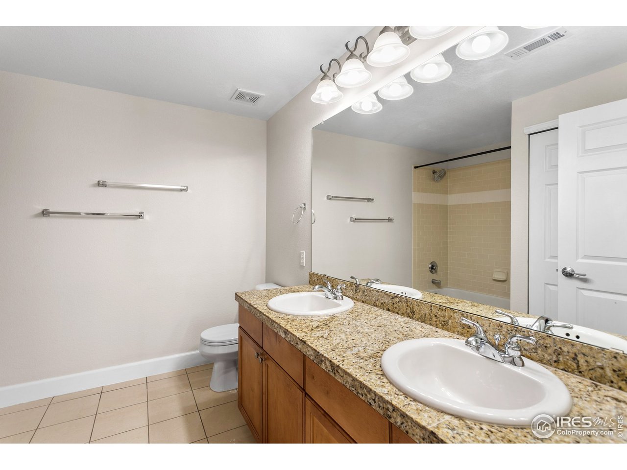 4500 Baseline Road, Unit 3302 Boulder, CO 80303 - Photo 6 of 22 a bathroom with a granite countertop sink a toilet and a mirror