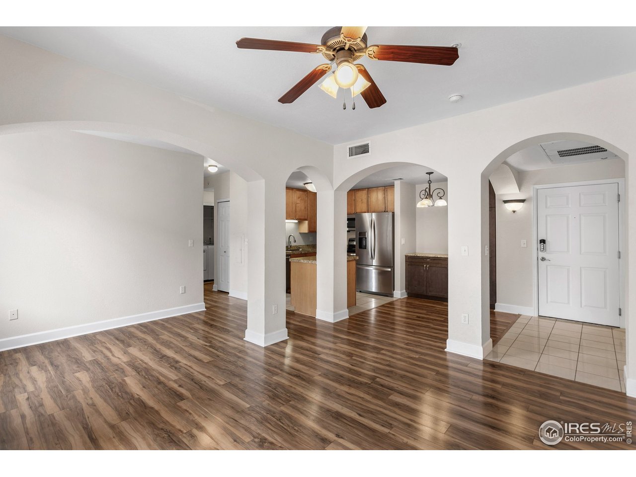 4500 Baseline Road, Unit 3302 Boulder, CO 80303 - Photo 10 of 22 a view interior of a house with wooden floor a ceiling fan and windows