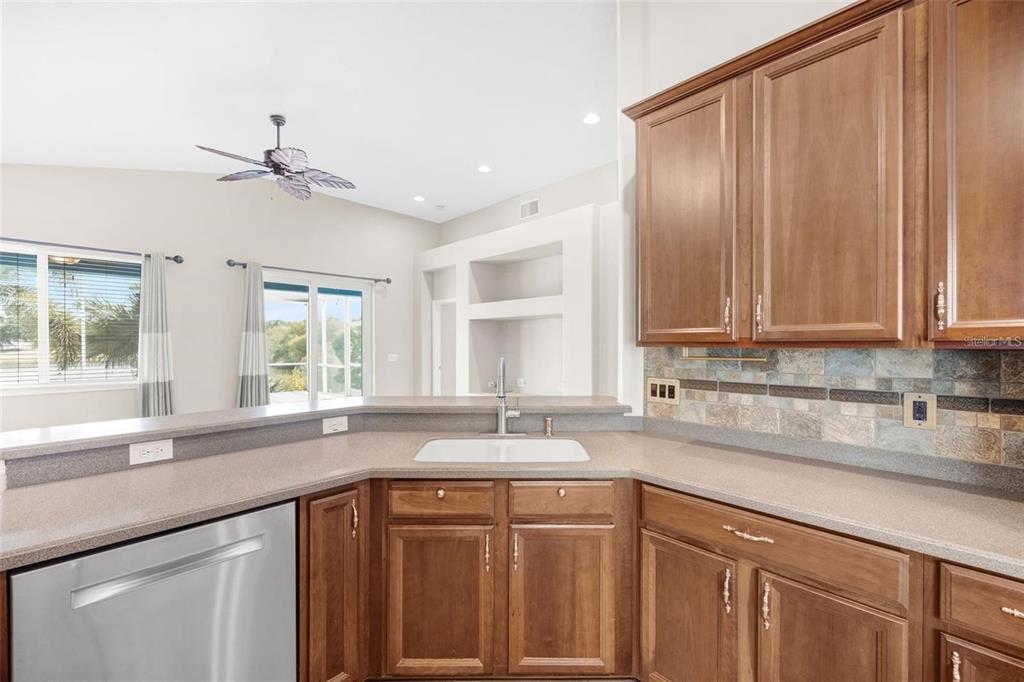 5124 Clover Mist Drive Apollo Beach, FL 33572 - Photo 11 of 52 a kitchen with stainless steel appliances granite countertop a sink a window and cabinets
