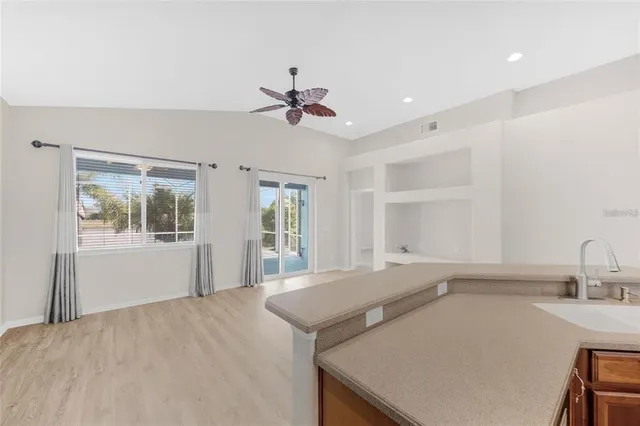 a view of a kitchen with a sink and a window