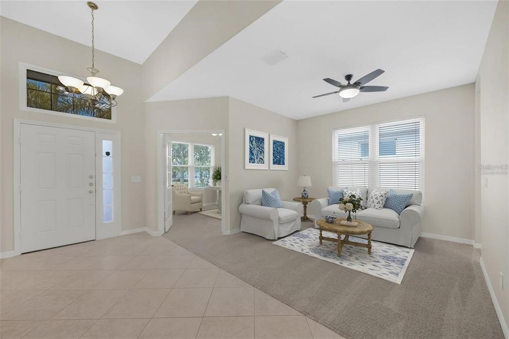 5124 Clover Mist Drive Apollo Beach, FL 33572 - Photo 21 of 52 a living room with furniture chandelier and a window