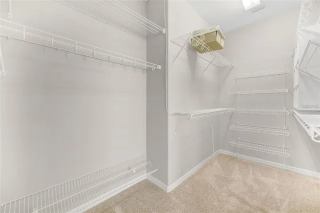 an empty room with a window and a ceiling fan