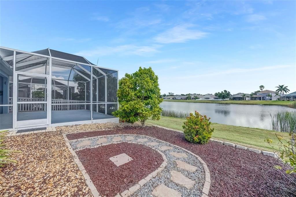 5124 Clover Mist Drive Apollo Beach, FL 33572 - Photo 4 of 52 a front view of a house with a yard and lake view