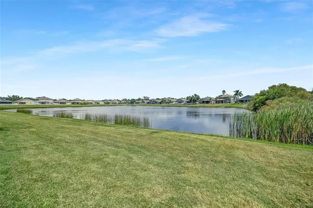 a view of a lake with houses in the back