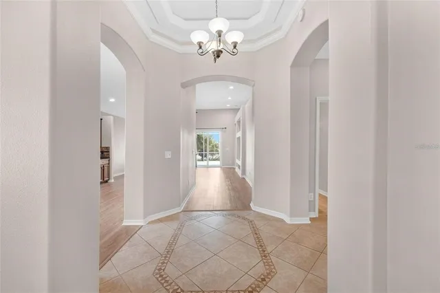a view of a hallway with a chandelier