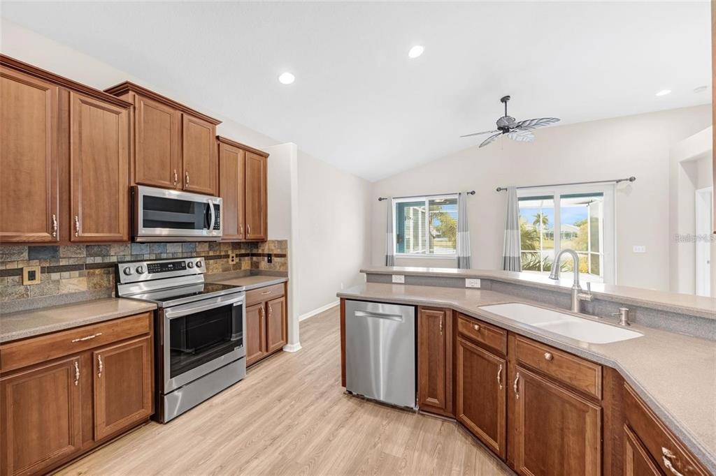 5124 Clover Mist Drive Apollo Beach, FL 33572 - Photo 10 of 52 a kitchen with stainless steel appliances granite countertop a sink stove and microwave