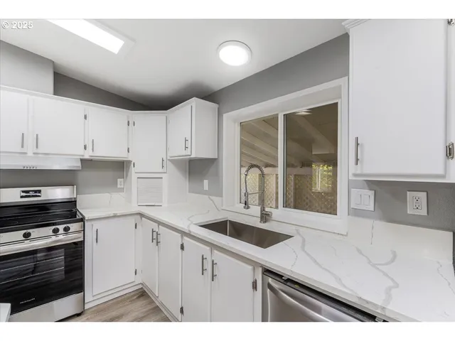 a kitchen that has a sink and a stove