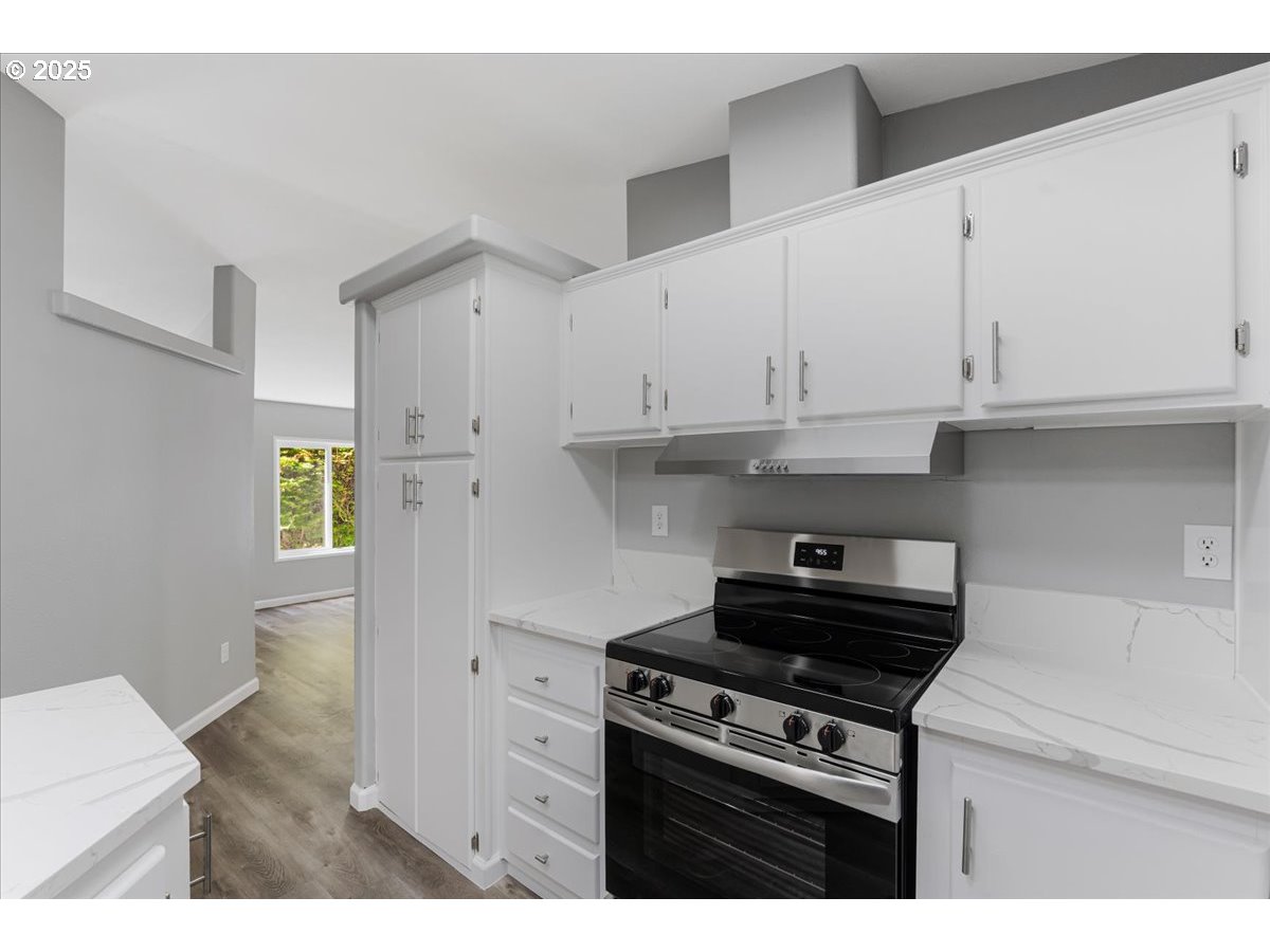 369 Gun Club Road, Unit 117 Woodland, WA 98674 - Photo 12 of 29 a kitchen with stainless steel appliances white cabinets and stove