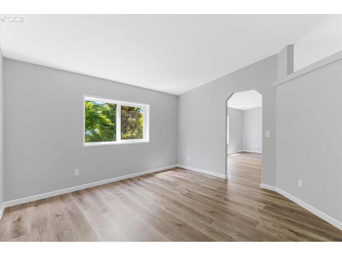 369 Gun Club Road, Unit 117 Woodland, WA 98674 - Photo 16 of 29 a view of an empty room with wooden floor and window