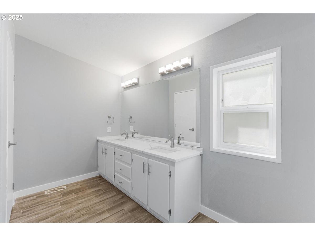 369 Gun Club Road, Unit 117 Woodland, WA 98674 - Photo 19 of 29 a bathroom with a double vanity sink and a mirror