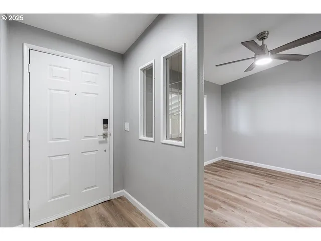 a view of an empty room and wooden floor