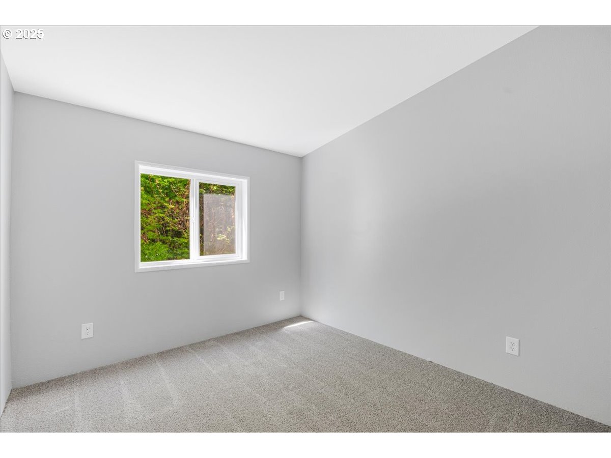 369 Gun Club Road, Unit 117 Woodland, WA 98674 - Photo 21 of 29 a view of an empty room with a window