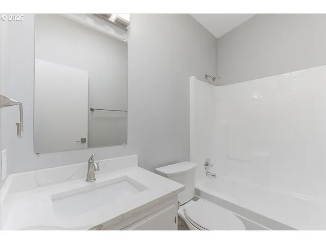 a bathroom with a bathtub sink vanity and a mirror