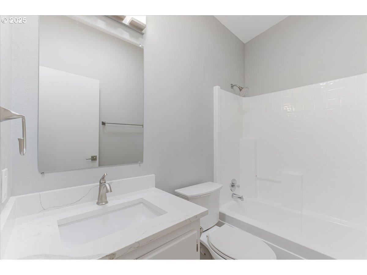 369 Gun Club Road, Unit 117 Woodland, WA 98674 - Photo 23 of 29 a bathroom with a bathtub sink vanity and a mirror