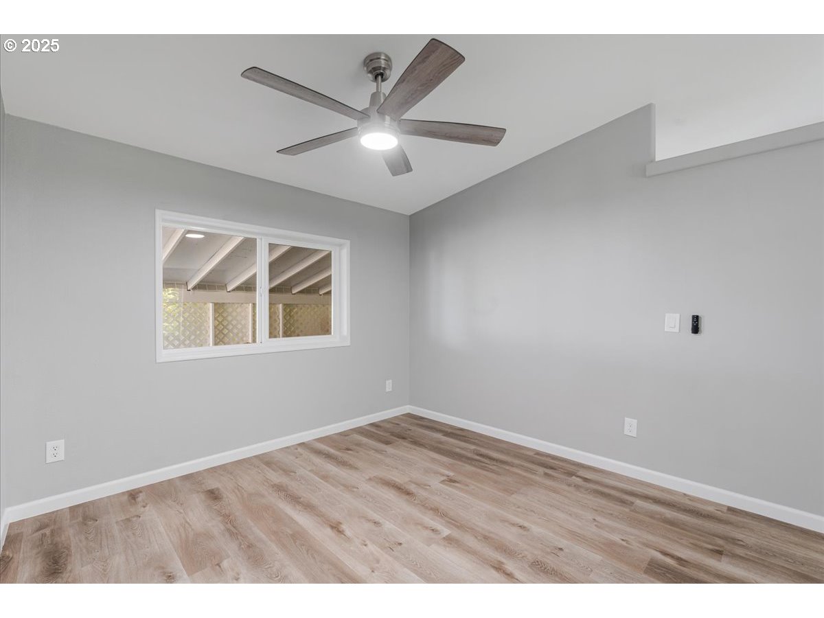 369 Gun Club Road, Unit 117 Woodland, WA 98674 - Photo 5 of 29 a view of an empty room with wooden floor and a window