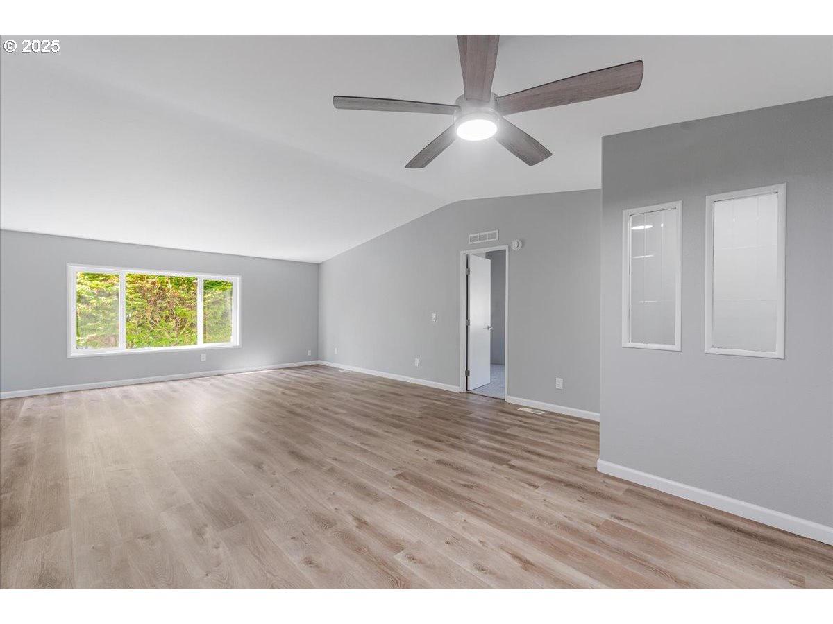 369 Gun Club Road, Unit 117 Woodland, WA 98674 - Photo 7 of 29 a view of an empty room with wooden floor and a window
