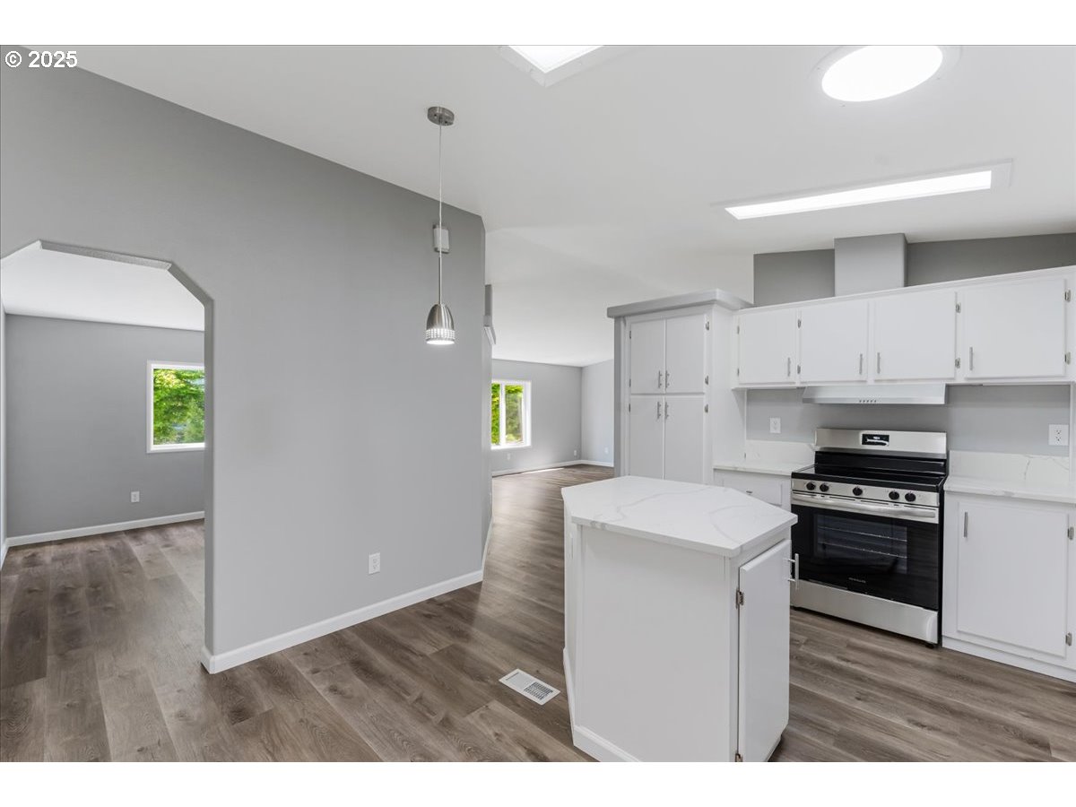 369 Gun Club Road, Unit 117 Woodland, WA 98674 - Photo 9 of 29 a kitchen with a stove a sink and a refrigerator