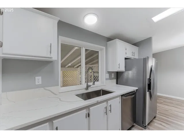 a kitchen with stainless steel appliances a refrigerator and a sink