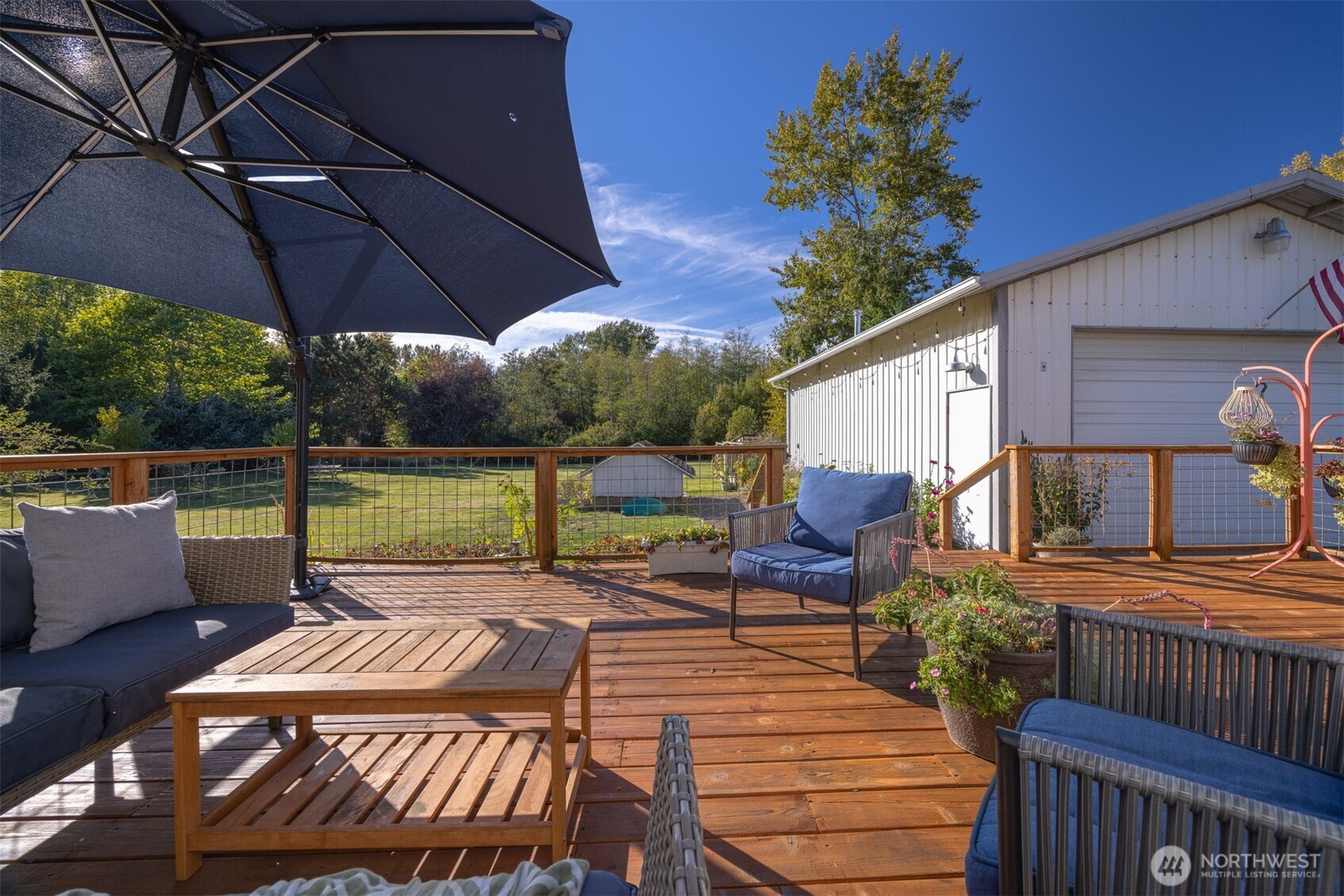 3895 Bancroft Road Bellingham, WA 98225 - Photo 22 of 40 a view of a patio with table and chairs under an umbrella
