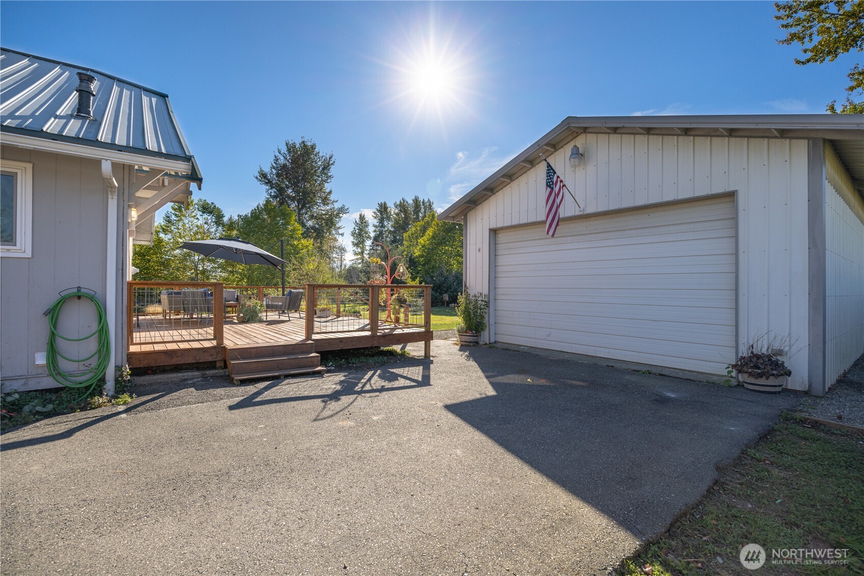 3895 Bancroft Road Bellingham, WA 98225 - Photo 23 of 40 a backyard of a house with barbeque oven table and chairs