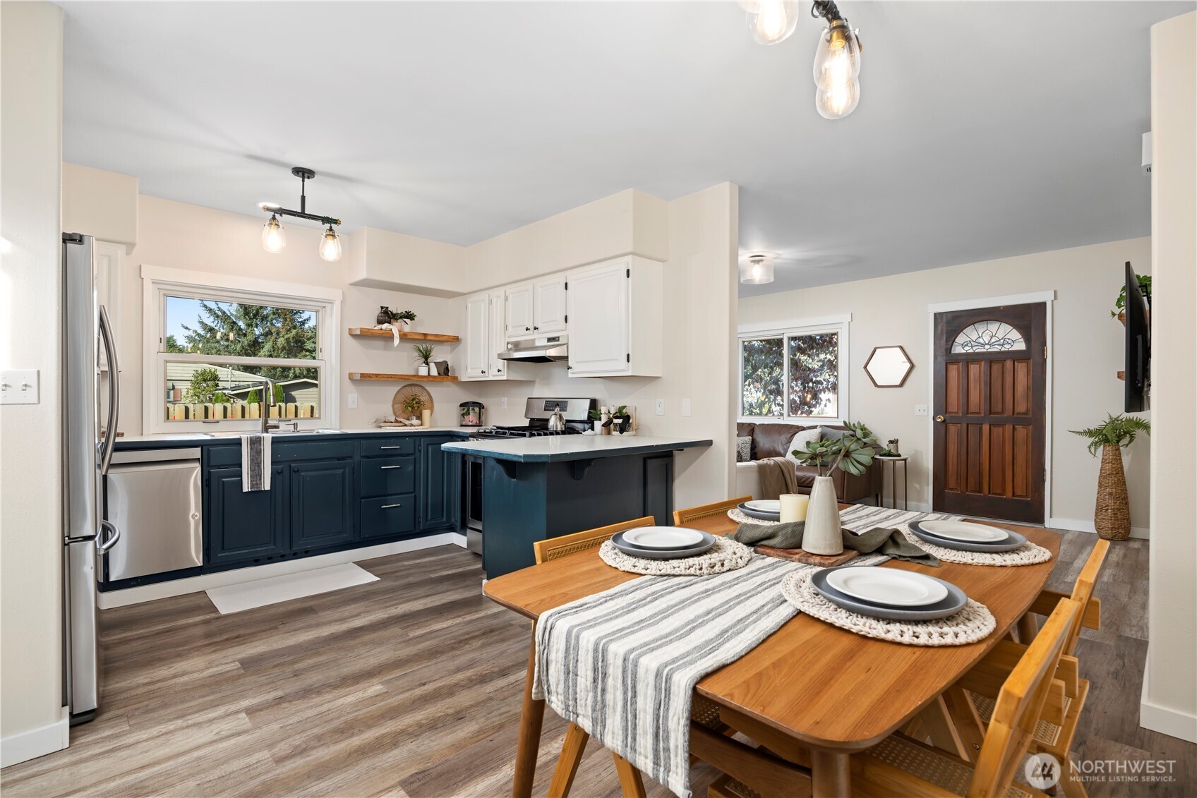 3895 Bancroft Road Bellingham, WA 98225 - Photo 5 of 40 a kitchen with a dining table chairs and refrigerator
