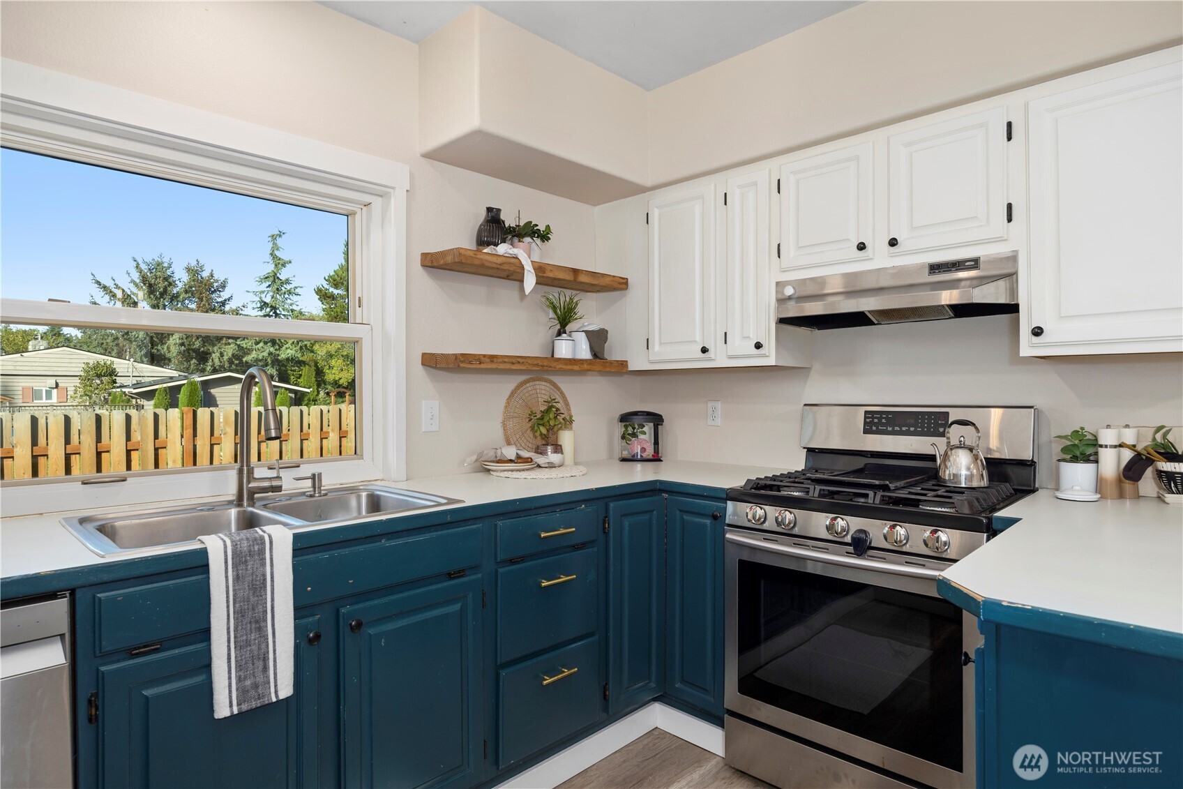 3895 Bancroft Road Bellingham, WA 98225 - Photo 6 of 40 a kitchen with stainless steel appliances a stove a sink and a window