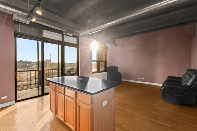a kitchen with granite countertop sink and natural light