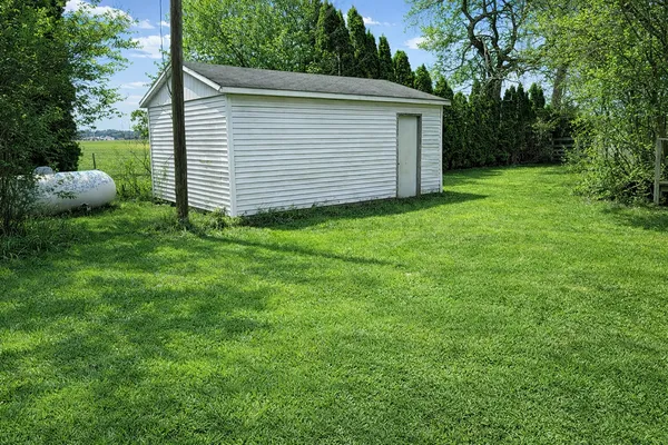 a view of backyard of house and garden