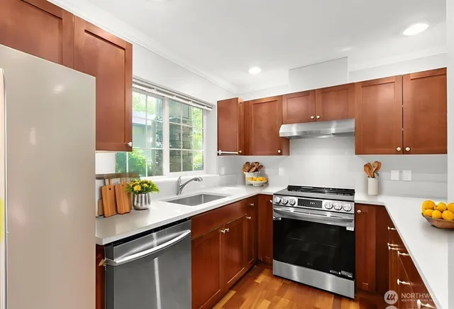 a kitchen with a sink stove and cabinets