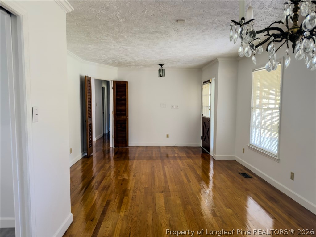 598 Forest Road Lumberton, NC 28358 - Photo 4 of 25 an empty room with wooden floor and windows