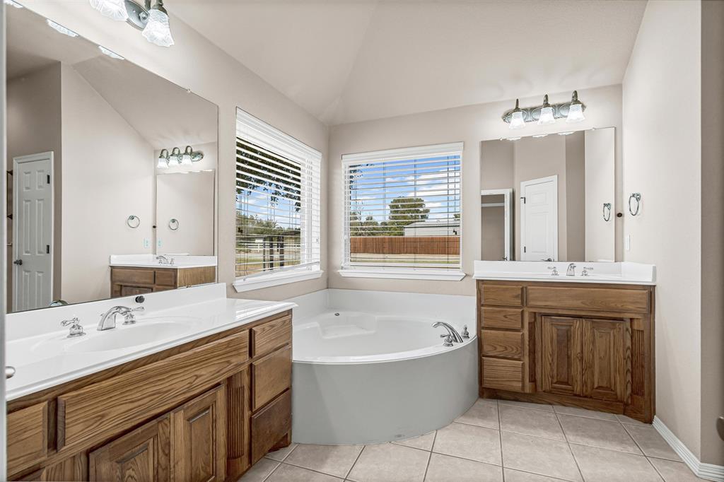 6009 Feather Wind Way Fort Worth, TX 76135 - Photo 13 of 19 a bathroom with a tub sink and mirror