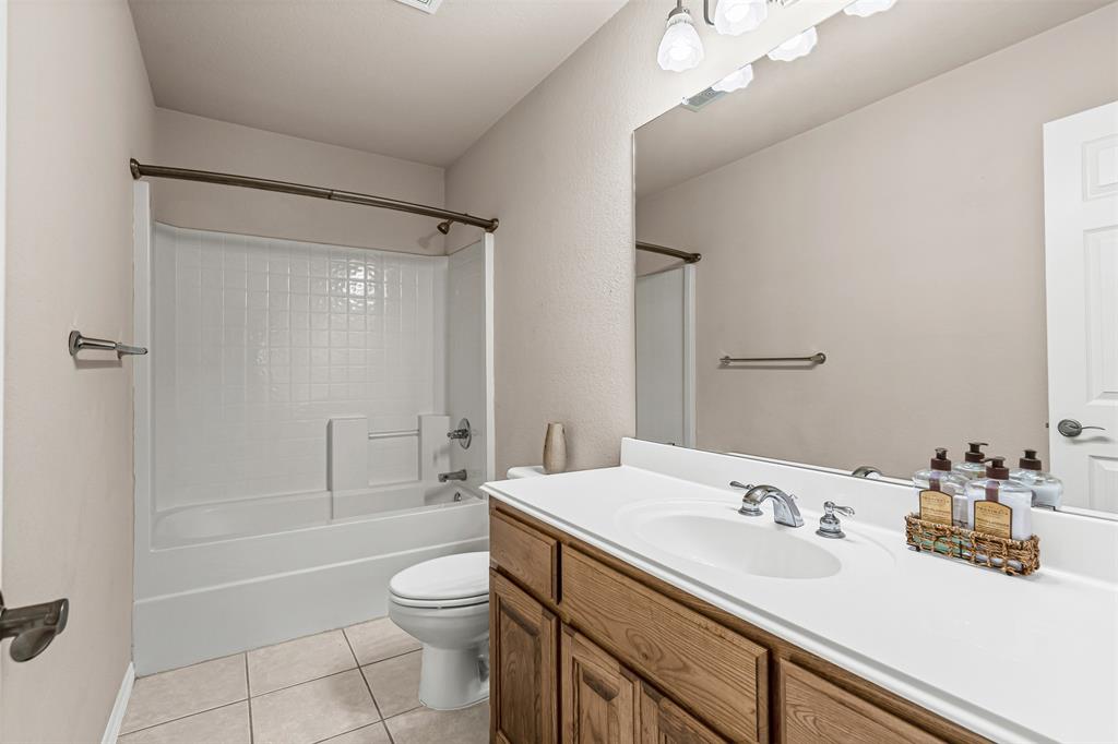 6009 Feather Wind Way Fort Worth, TX 76135 - Photo 18 of 19 a bathroom with a sink a toilet and shower