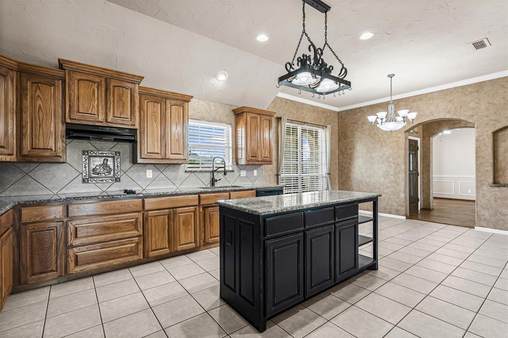 6009 Feather Wind Way Fort Worth, TX 76135 - Photo 10 of 19 a kitchen with granite countertop a sink and cabinets