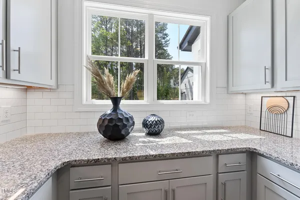 a kitchen with granite countertop a sink and a window