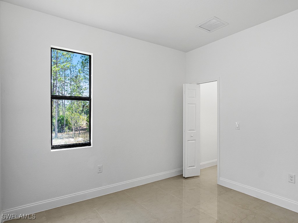 902 Williams Avenue Lehigh Acres, FL 33972 - Photo 19 of 30 an empty room with windows