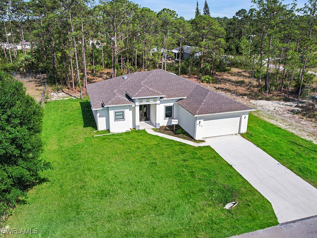 902 Williams Avenue Lehigh Acres, FL 33972 - Photo 2 of 30 a aerial view of a house with a yard