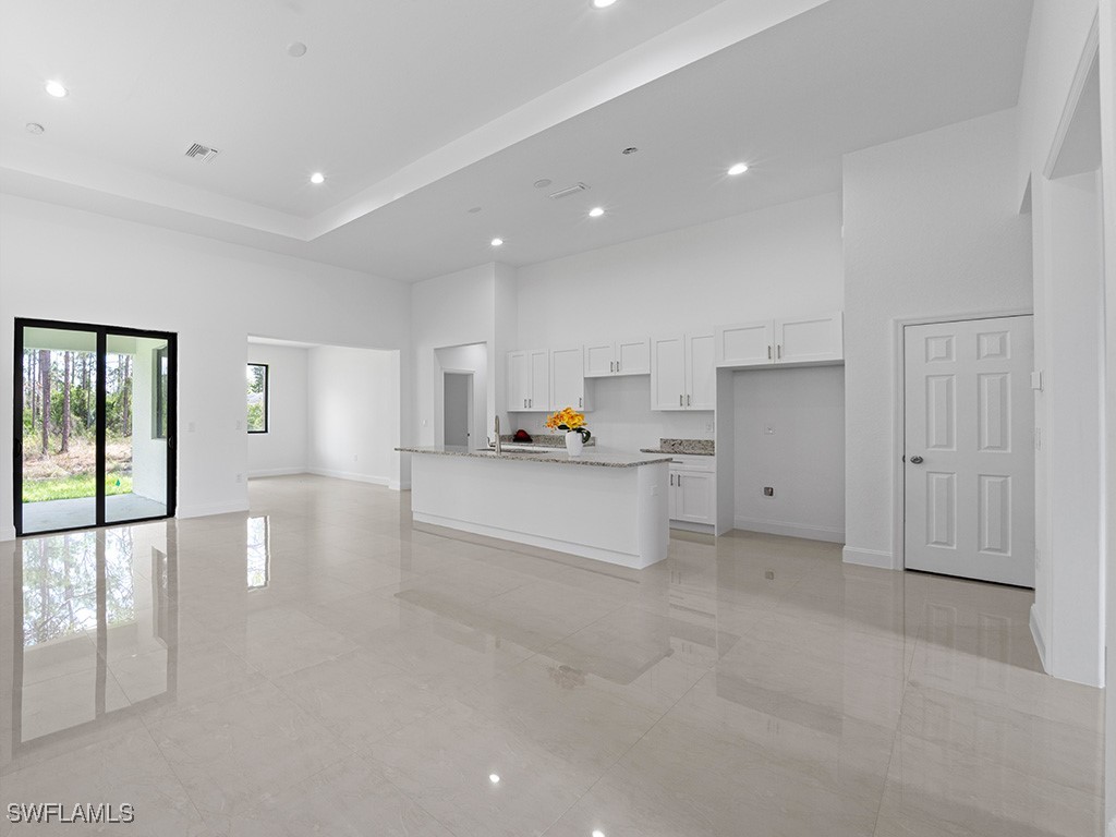 902 Williams Avenue Lehigh Acres, FL 33972 - Photo 24 of 30 a view of a kitchen with refrigerator and windows
